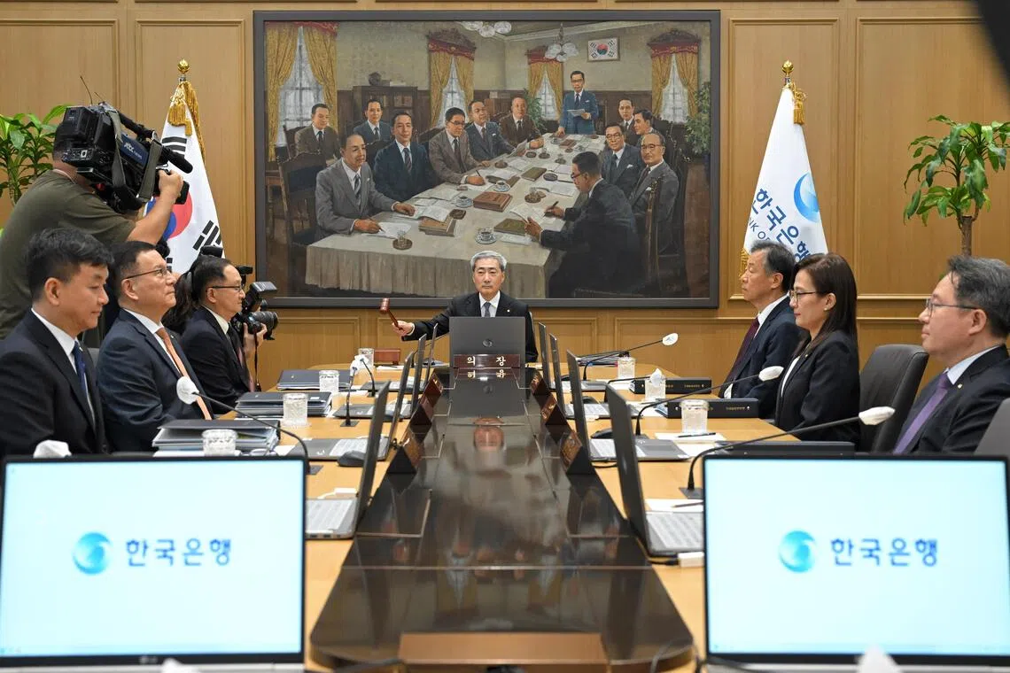 Bank of Korea Governor Shin Hyun-song bangs the gavel to open a Monetary Policy Committee meeting at the central bank in Seoul on Aug 27.
