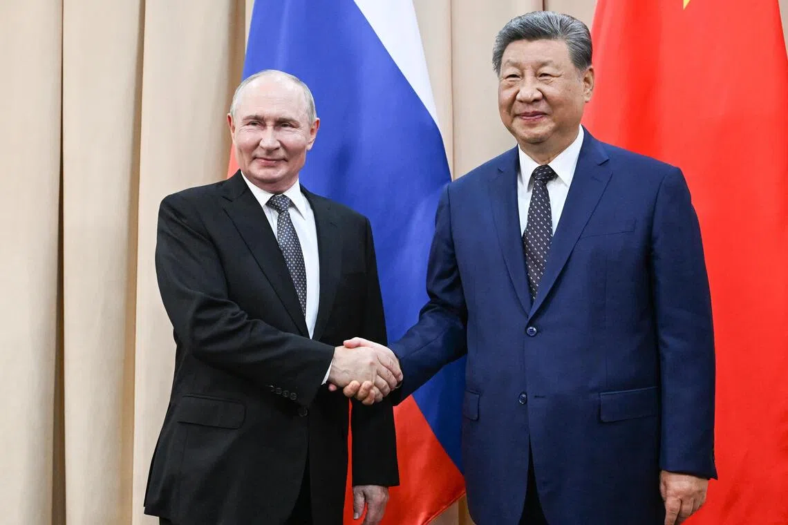 Russian President Vladimir Putin (left) and Chinese President Xi Jinping shaking hands on the sidelines of the Shanghai Cooperation Organisation summit in Bishkek, Kyrgyzstan, on Aug 31.