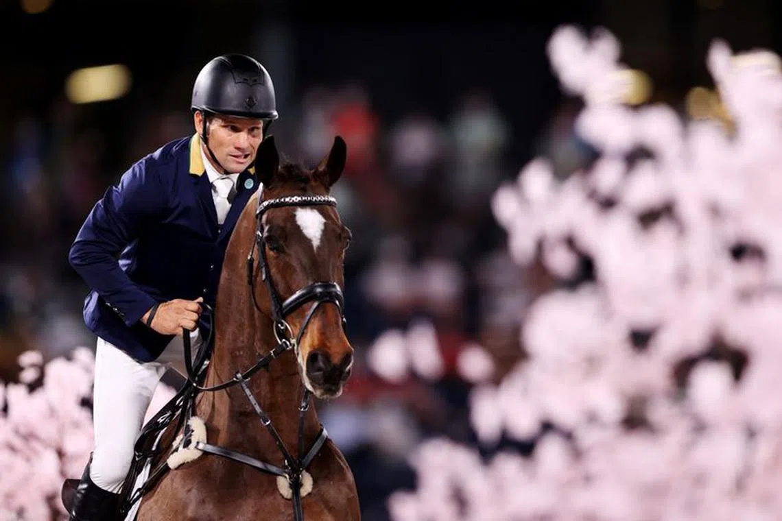 FILE PHOTO: Tokyo 2020 Olympics - Equestrian - Eventing - Jumping Individual - Final - Equestrian Park - Tokyo, Japan - August 2, 2021. Shane Rose of Australia on his horse Virgil competes. REUTERS/Molly Darlington/File Photo