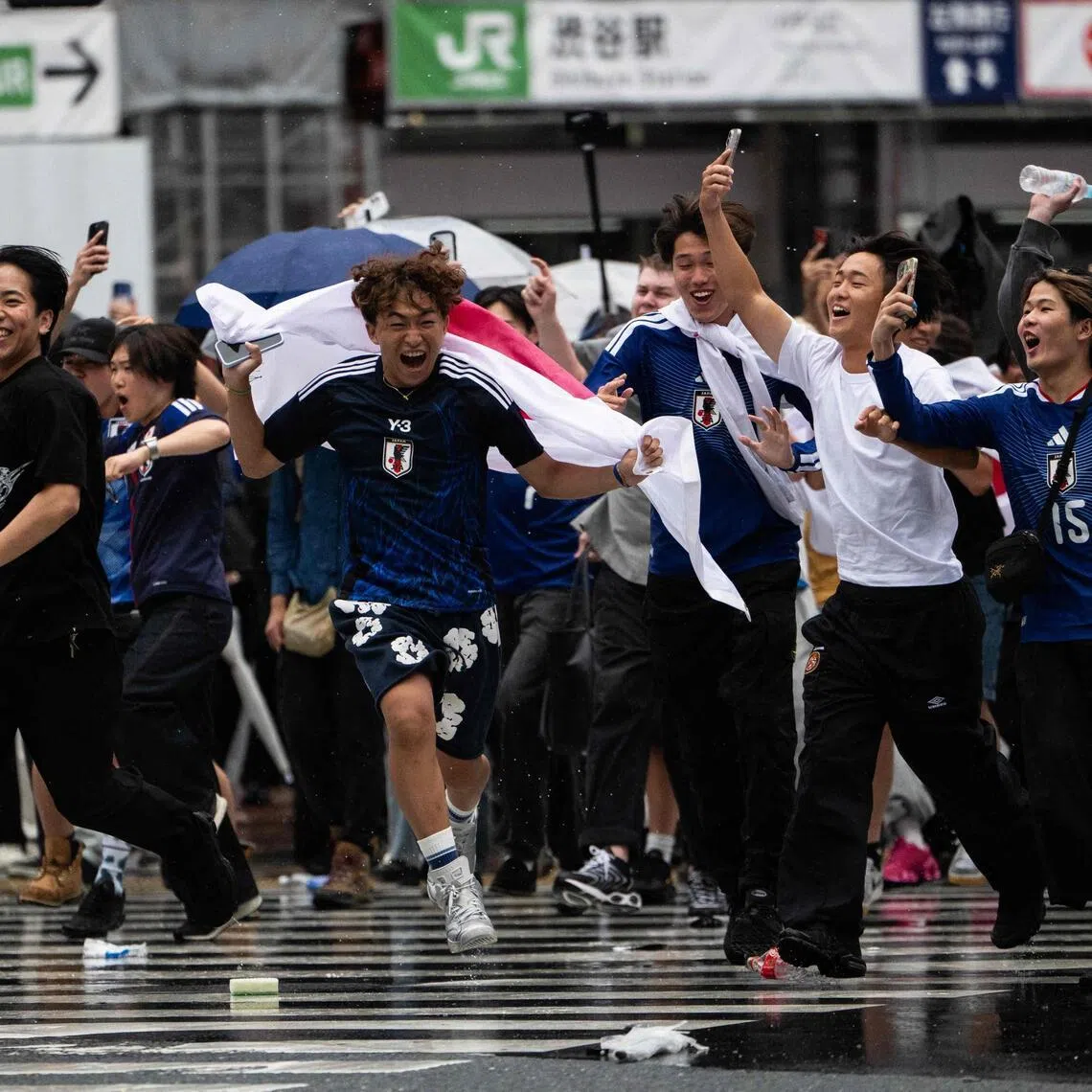Fans celebrate at Shibuya crossing in Tokyo on June 15, after Japan's 2-2 draw with the Netherlands in the World Cup.