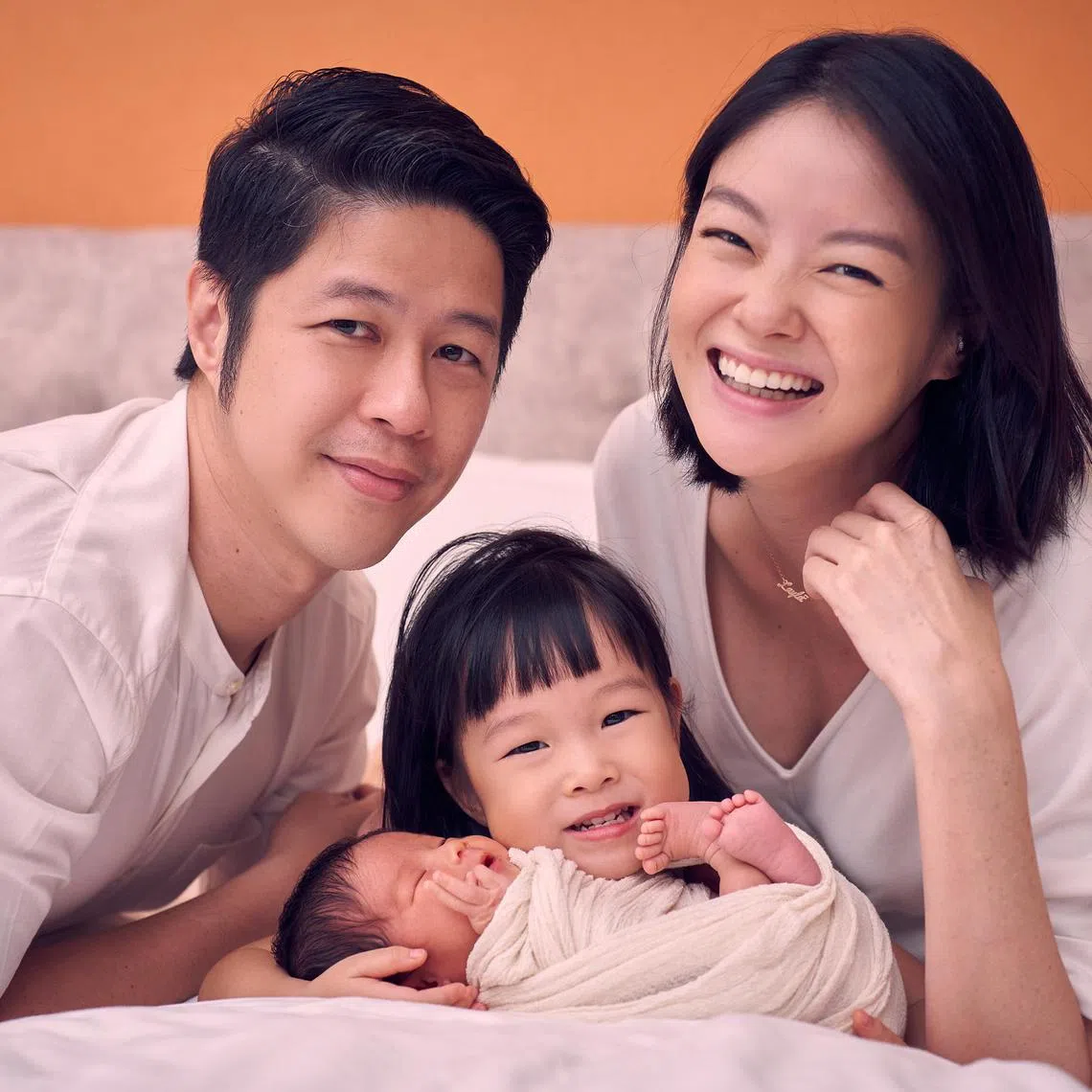 Actress Sheila Sim and her bank executive-husband Deon Woo with their toddler daughter Layla and newborn Skyla.