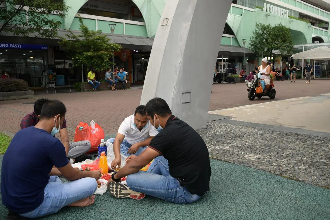 A group of migrant workers gathered at Jurong East on June 26, 2022. They had applied for the Popular Places Pass.