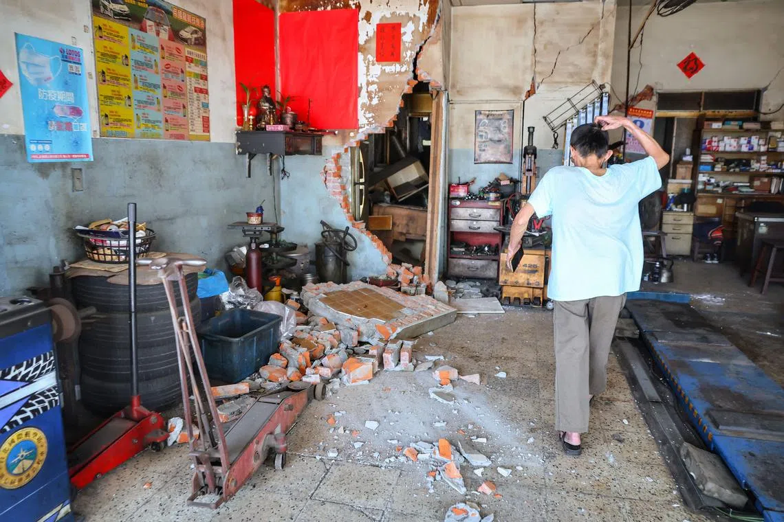A man reacting after a brick wall in a house collapsed in Taipei, following a major earthquake in eastern Taiwan, on April 3, 2024.