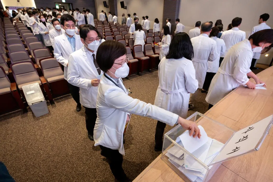 A professor at a medical school submits a resignation form at a hospital in Seoul, South Korea, March 25, 2024.    Yonhap via REUTERS