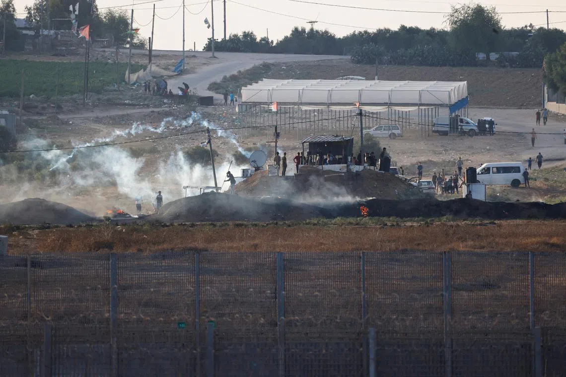 Israeli soldiers and Palestinian protesters clash near the border between Israel and the Gaza Strip as seen from the Israeli side, September 23, 2023. REUTERS/Amir Cohen/File Photo