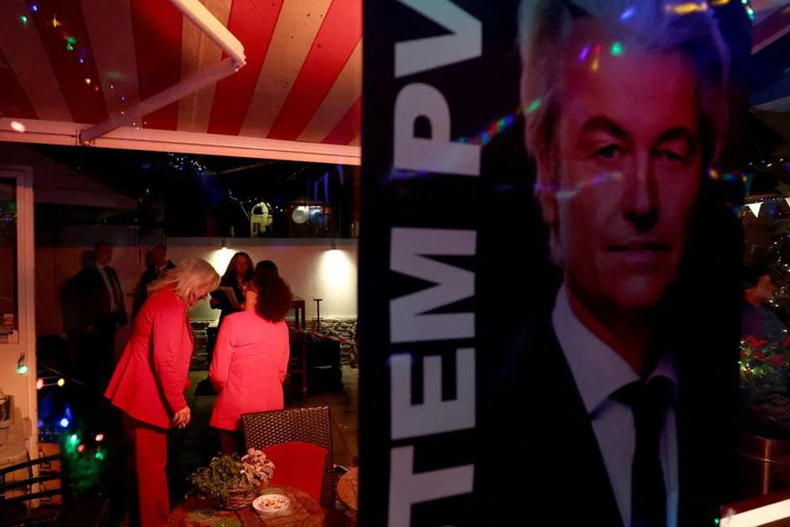 Supporters of Dutch far-right politician and leader of the PVV party Geert Wilders react to the exit poll and early results in the Dutch parliamentary elections, in The Hague, Netherlands November 22, 2023. REUTERS/Yves Herman