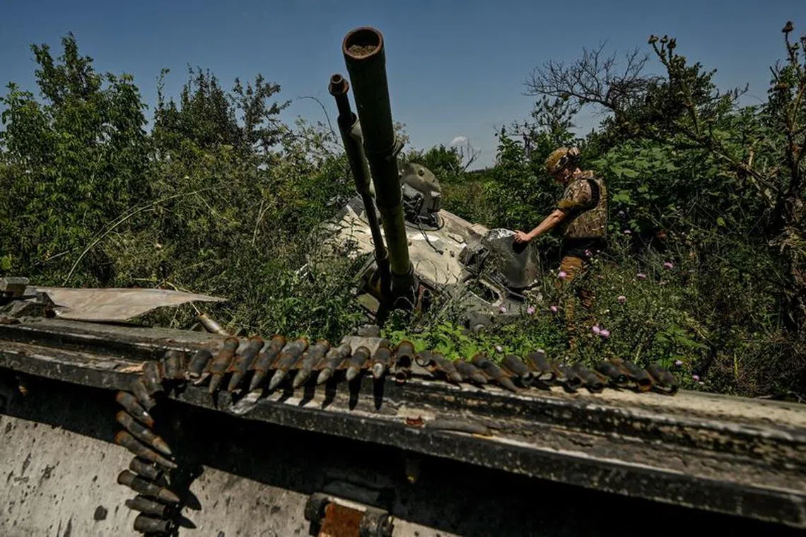 FILE PHOTO: A Ukrainian serviceman inspects a turret of a destroyed Russian BMP-3 infantry fighting vehicle in the recently liberated village of Novodarivka, Ukraine July 21, 2023. REUTERS/Stringer