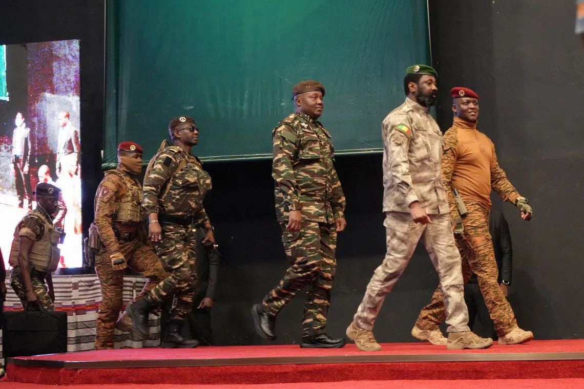Heads of state of Mali's Assimi Goita, Burkina Faso's Captain Ibrahim Traore and Niger's General Abdourahamane Tiani walk together during the first ordinary summit of heads of state and governments of the Alliance of Sahel States (AES) in Niamey, Niger July 6, 2024. REUTERS/Mahamadou Hamidou