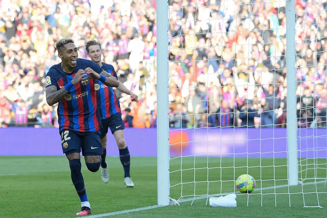 Barcelona forward Raphinha celebrating after scoring his team's first goal during the La Liga match against Valencia at the Camp Nou stadium in Barcelona.
