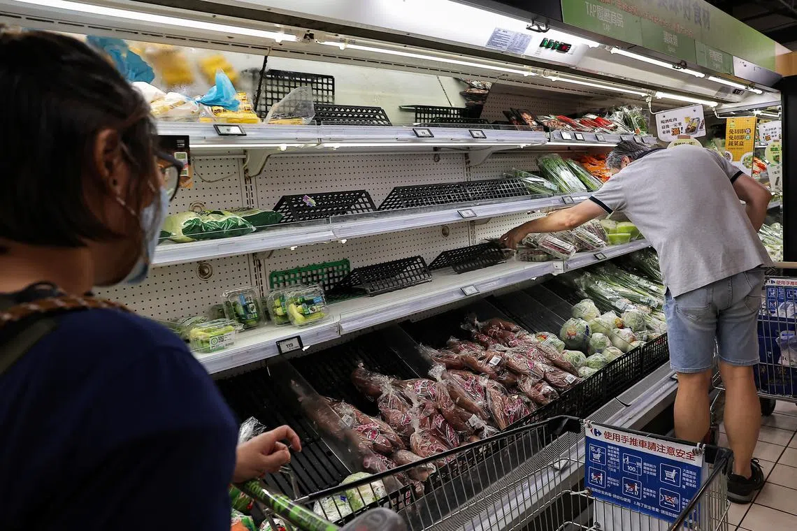 People buy food at a supermarket ahead of Typhoon Krathon which is expected to intensify and make an unusual landfall on Taiwan's densely populated west coast in the early hours of Wednesday in Taipei, Taiwan September 30, 2024. REUTERS/Ann Wang