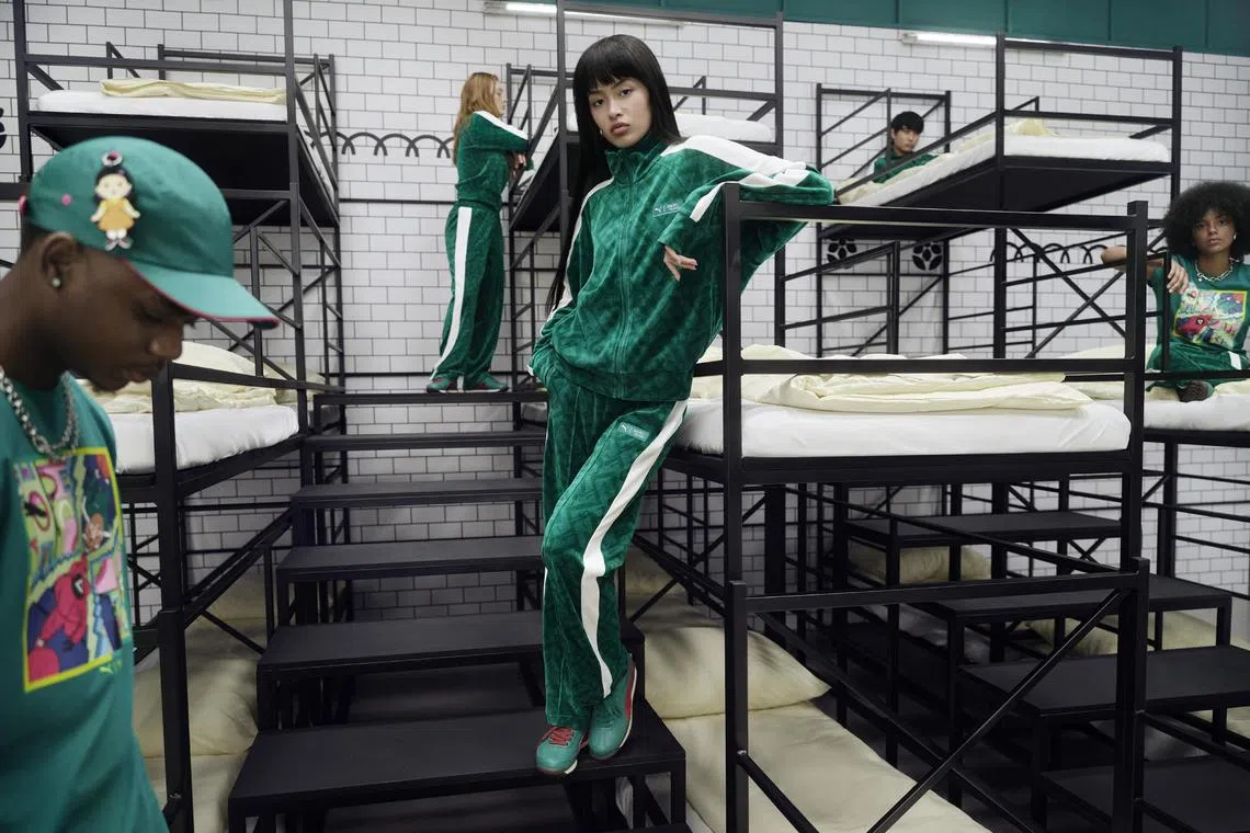 The Puma x Netflix Squid Game collection features the iconic green and white tracksuit, footwear and accessories. 