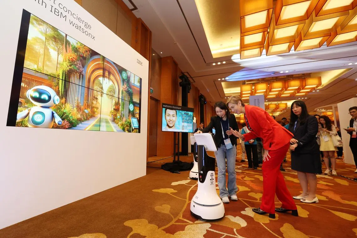 CMG20240815-HoKJ01  张俊 / 何家俊  IBM THINK 2024 conference. Media demo tour of THINK innovation showcase   Keynote address by Minister Josephine Teo   Panel Sessions [Sands Expo & Convention Centre ] 

Minister Teo viewed showcases by IBM, I4 Studio, a Smart Concierge Robot Solution using generative AI. The solution visualized transformation in the customer service function using IBM watsonx, integrating AI (Artificial Intelligence) and Digital Human to infuse advanced perception and decision-making intelligence in human-machine interaction.
The example used illustrated a digital experience at a tourist attraction. The booth reflected a tourist location – a wildlife park. The demo will allow you to interact with an autonomous mobile robot that acts as a smart concierge, offering real time support and personalized recommendations to create a great tourist experience. (L-R⁠) Ang Ai Kiar, Data Scientist, IBM(洪艾嘉) and Catherine Lian, General Manager & Technology Leader, IBM ASEAN, speaking with Minister Teo at the booth.