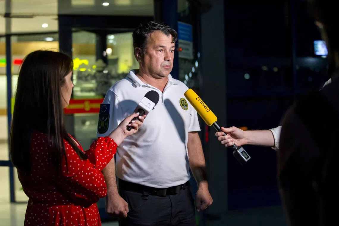 Border Police chief Rosian Vasiloi speaks to the media in front of Chisinau International Airport.