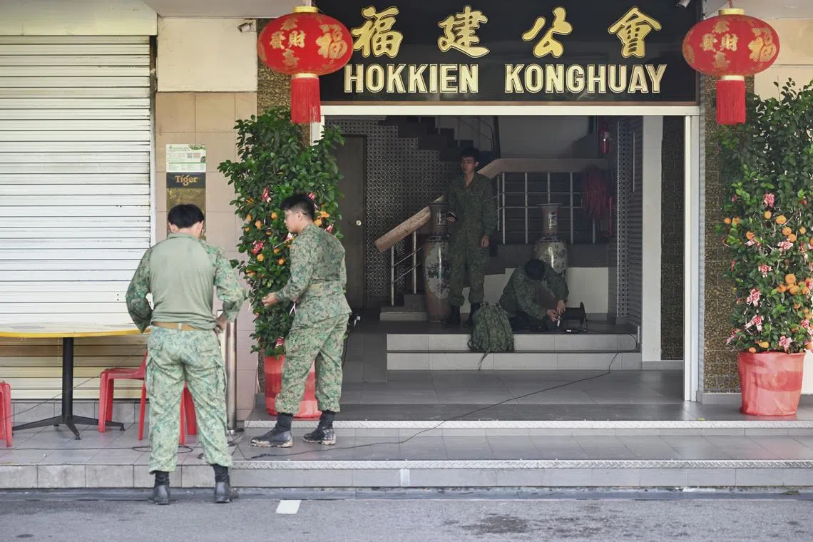 SAF personnel using a shophouse next to the construction site along Upper Bukit Timah Road for their operations. 