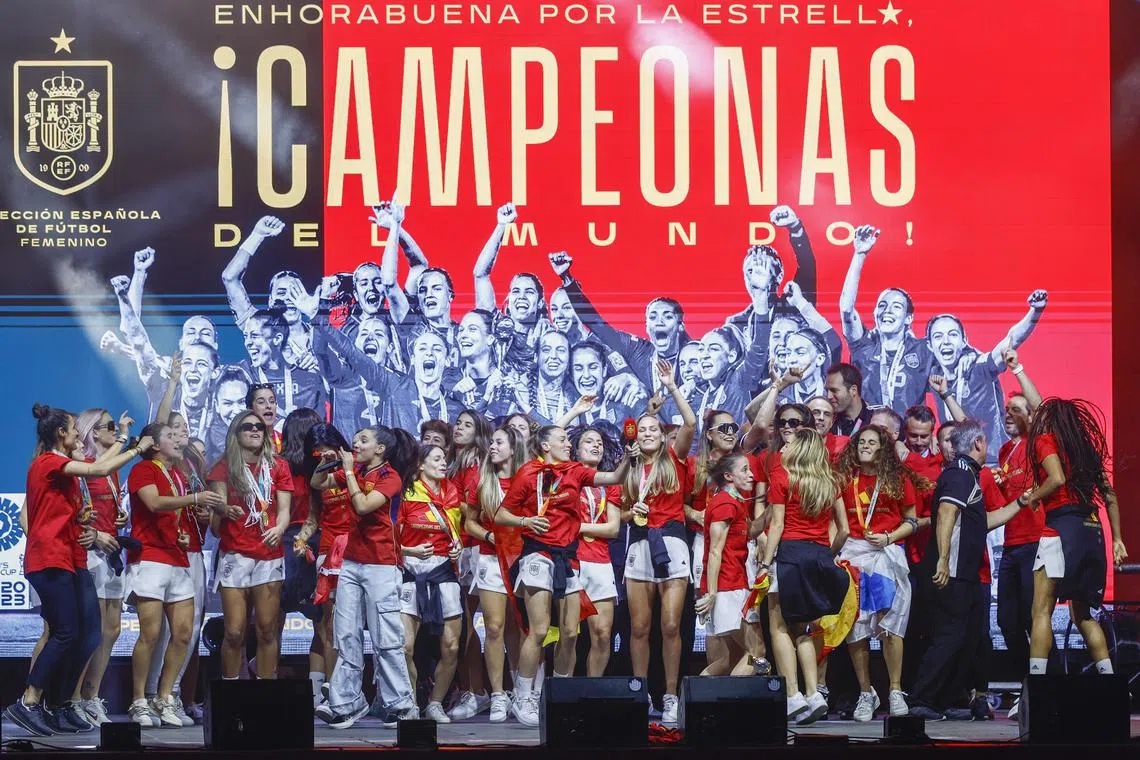 Spain's players dancing on stage in Madrid as they celebrate with supporters after winning the Women's World Cup.