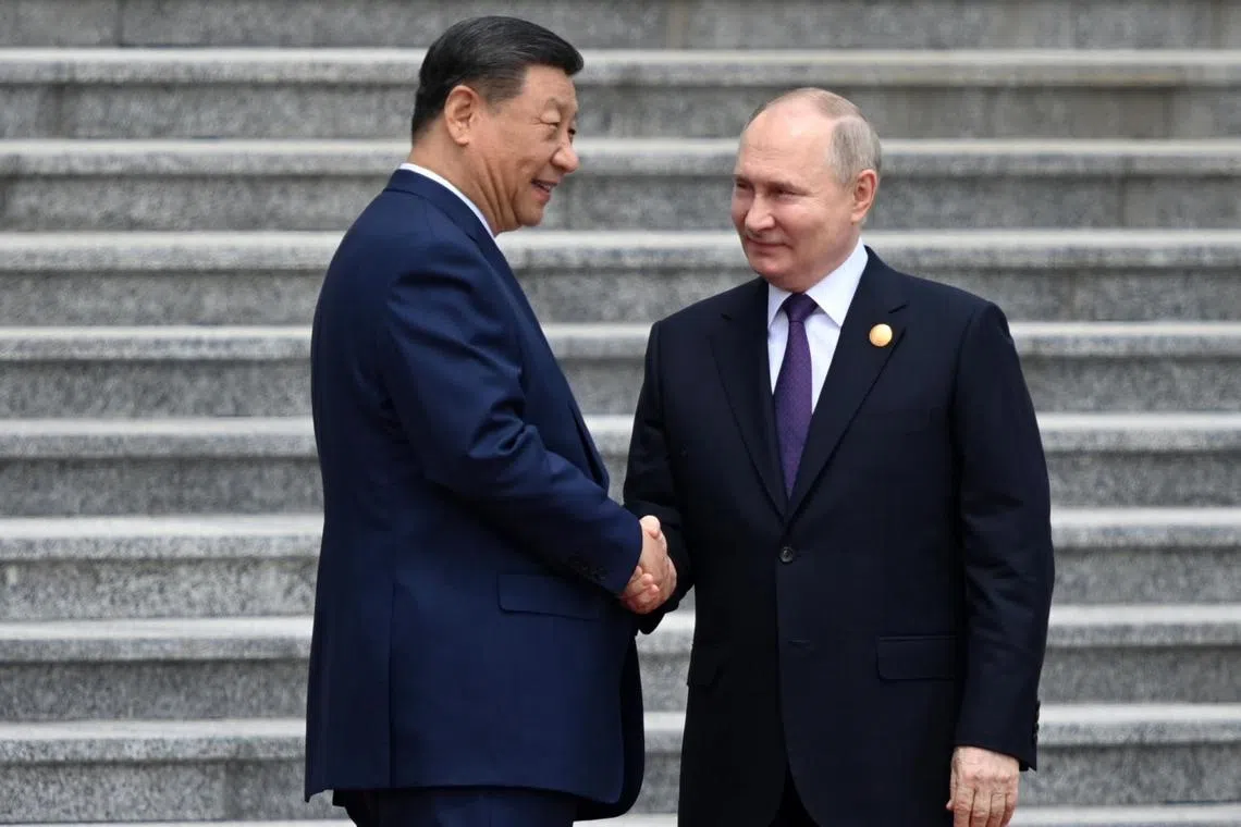 China's President Xi Jinping (left) welcoming Russian President Vladimir Putin to Beijing on May 16.