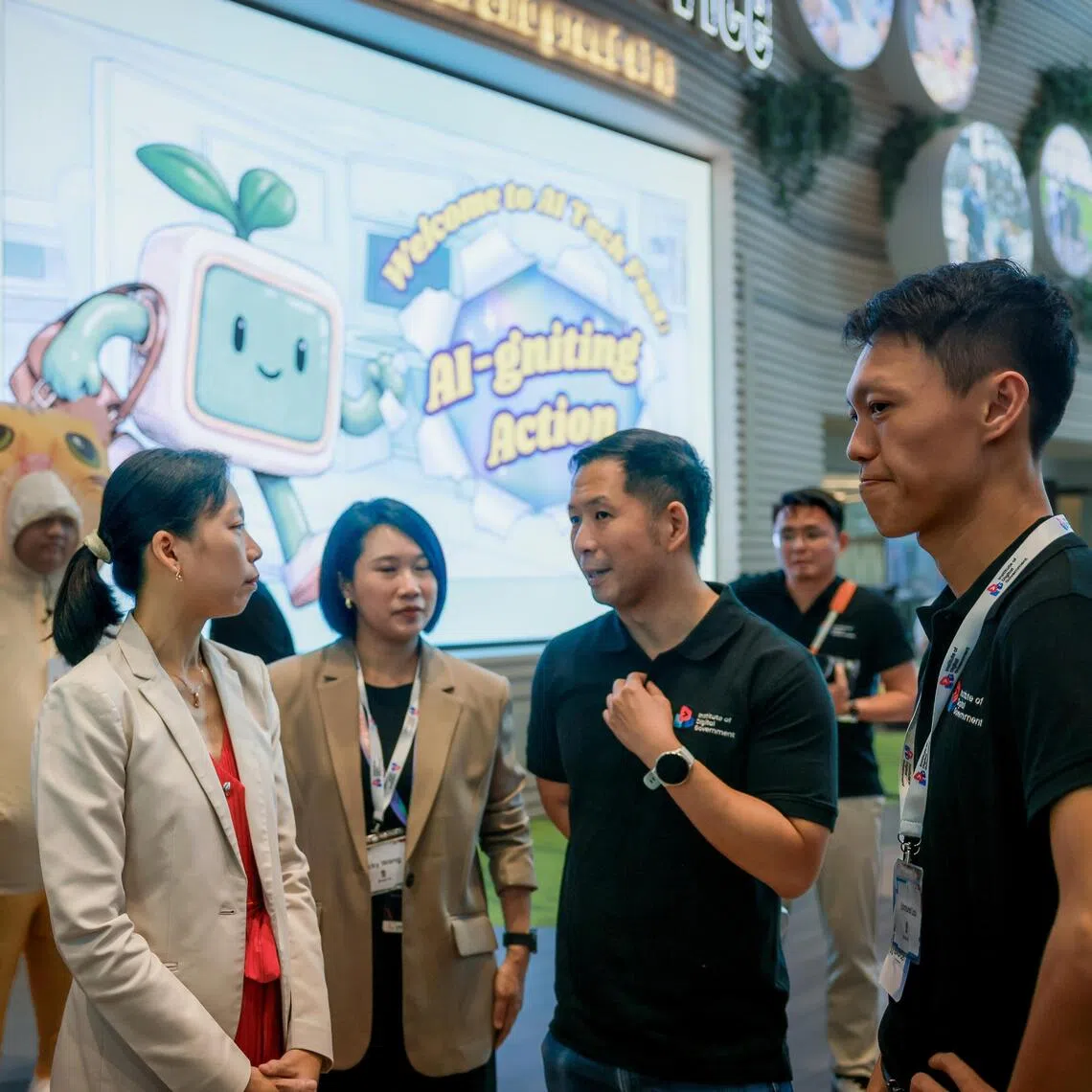 Senior Minister of State for Digital Development and Information Jasmin Lau (left) touring the AI Tech Festival during the launch of the Institute of Digital Government on Sept 18.