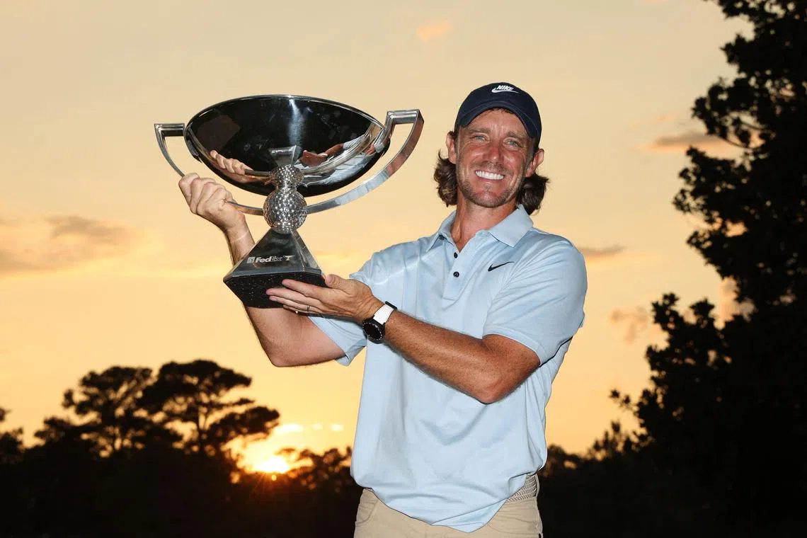 Tommy Fleetwood of England posing with the FedexCup trophy after winning the final round of the Tour Championship 2025 at East Lake Golf Club on Aug 24, 2025 in Atlanta, Georgia.