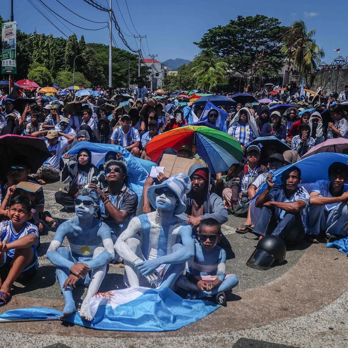TOPSHOT - Football fans watch a live broadcast of the 2026 FIFA World Cup quarter-final match between Argentina and Switzerland, won 1-0 by Argentina, during a public viewing in Ternate, North Maluku, on July 12, 2026. (Photo by AZZAM RIZQULLAH / AFP)