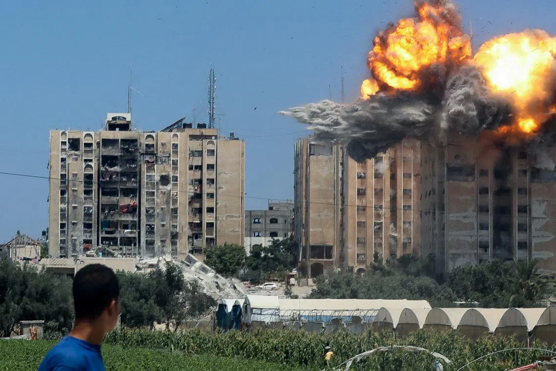 FILE PHOTO: An explosion occurs following an Israeli air strike on a residential building, amid the Israel-Hamas conflict, in Nuseirat in the central Gaza Strip, July 20, 2024. REUTERS/Omar Naaman/File Photo