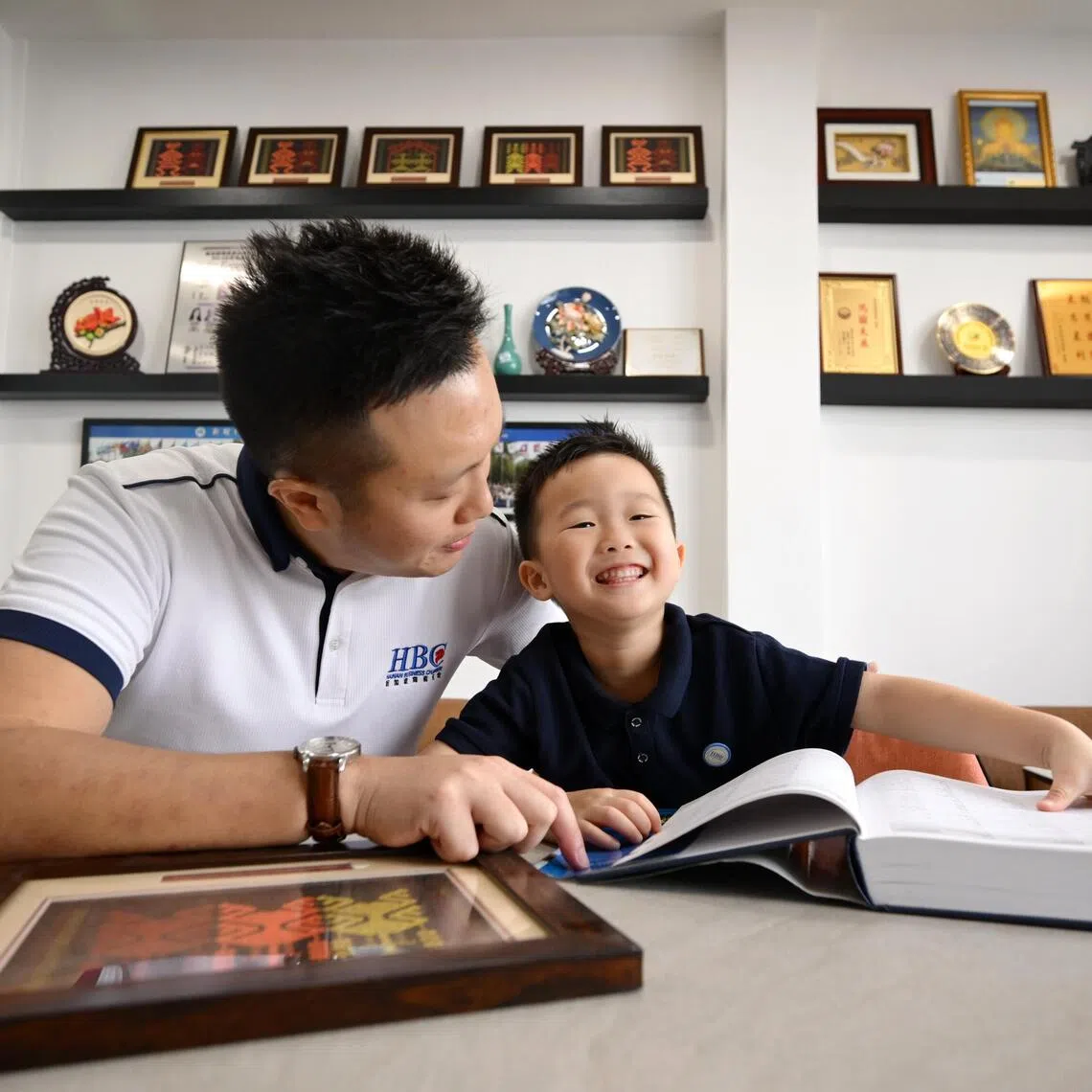 Eldred Wee exposing his son Eden to Hainanese language and culture at the Hainan Business Chamber.