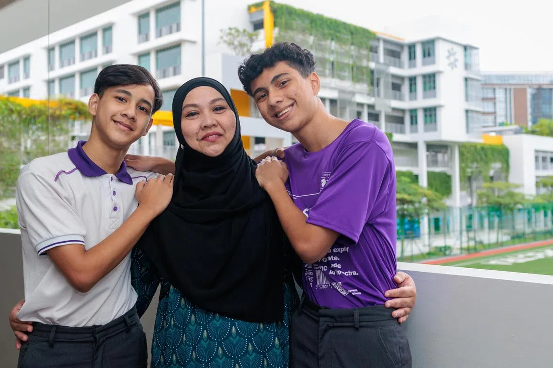 Spectra Secondary School student Nur Aiman Ahmad Raudha (right) with his younger brother Nur Aqmal and their mother Yuhana Abu Bakar.