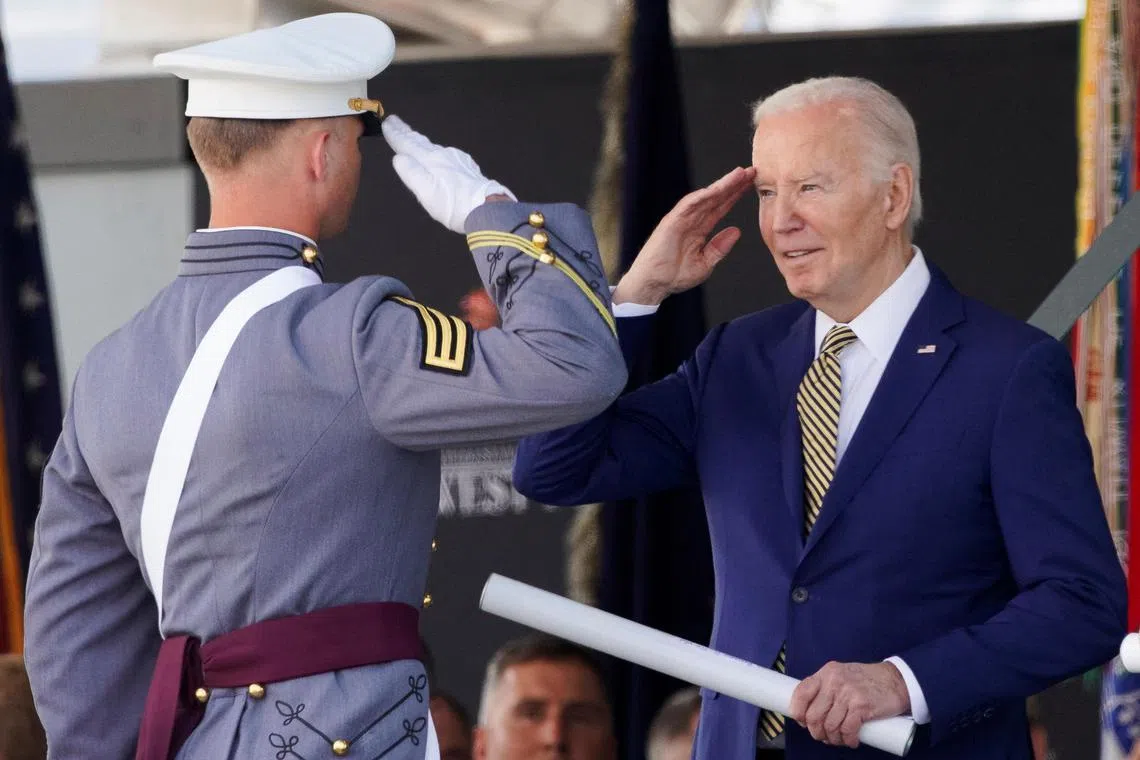 US President Joe Biden presenting a diploma to a graduating cadet at West Point Military Academy. on May 25.