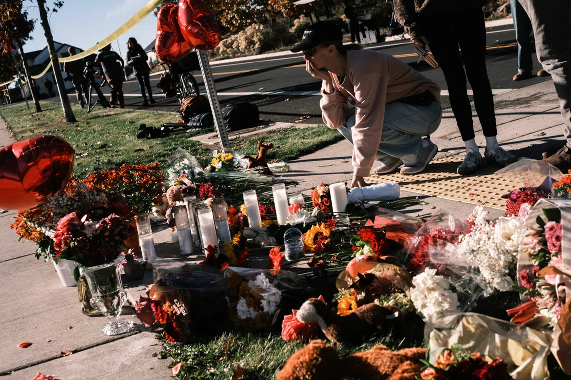 A woman reacts at a makeshift memorial outside of Silver Rail Elementary School in Bend, Oregon, on Oct 16.
