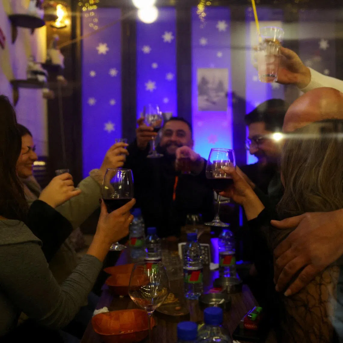 People enjoying a night out in the Bab Touma neighbourhood of the Old City of Damascus, after the ousting of President Bashar al-Assad in 2024.