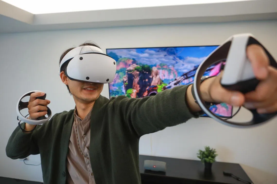 ST20230221_202300776497/ocvr22/Ryan Chiong
ST Reporter Osmond Chia wearing the PlayStation VR2 headset and controllers while playing Horizon Call of the Mountain for ST review on Feb 21, 2023.