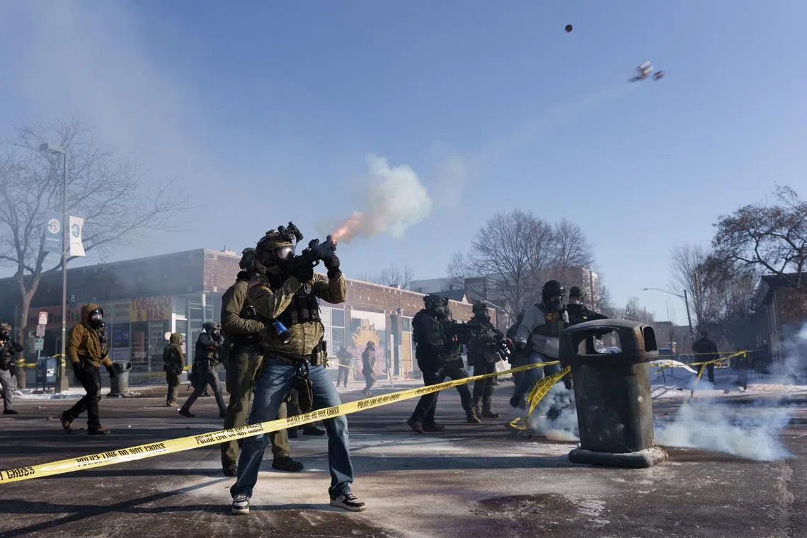 A federal agent fires a munition toward demonstrators near the site where a man identified as Alex Pretti was fatally shot by federal agents trying to detain him, in Minneapolis, Minnesota, U.S., January 24, 2026.REUTERS/Tim Evans