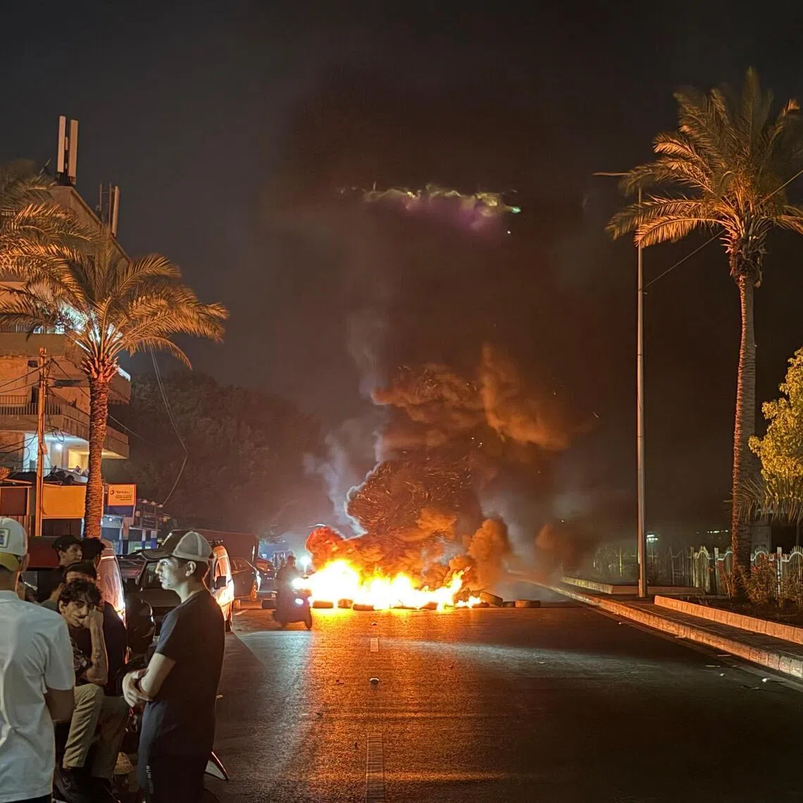 Hezbollah supporters block the old airport road in the southern suburbs of Beirut.