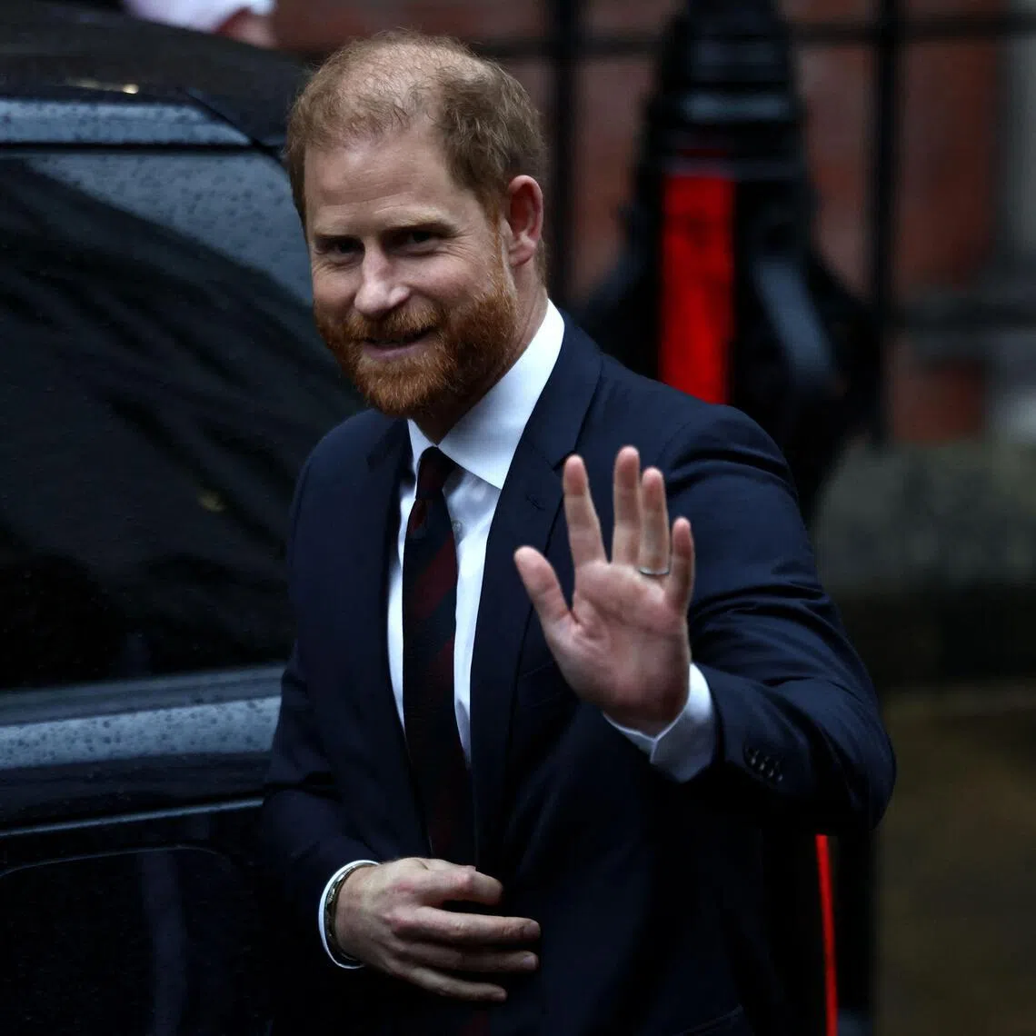 Britain's Prince Harry waving as he leaves the High Court in London on Jan 21, after giving testimony.