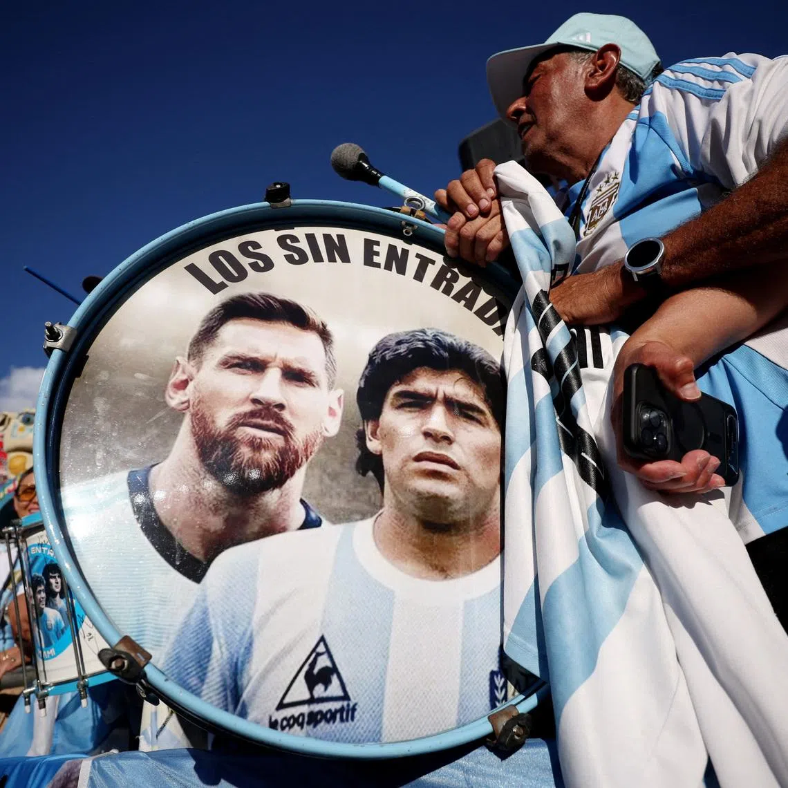 FILE PHOTO: Soccer Football - FIFA World Cup 2026 - Quarter Final - Argentina v Switzerland - Kansas City Stadium, Kansas City, Missouri, U.S. - July 11, 2026 Argentina fans play drums displaying Lionel Messi and Diego Maradona inside the stadium before the match REUTERS/Lee Smith/File Photo