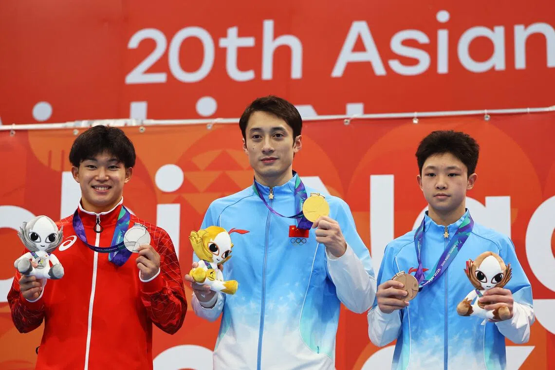 China’s Lian Junjie (centre) on the podium after winning the men’s 10m platform with silver medallist Rikuto Tamai of Japan and bronze medallist Zhao Renjie of China.
