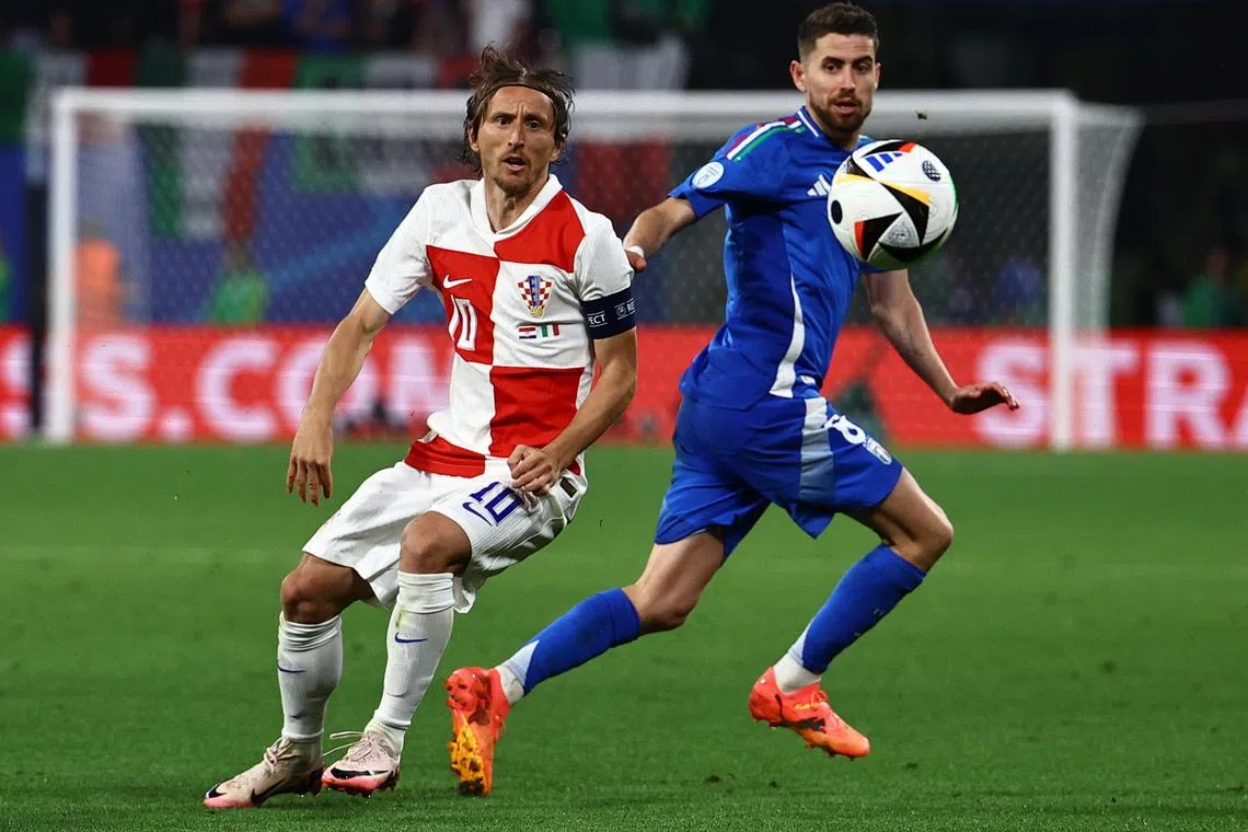 Luka Modric of Croatia and Jorginho of Italy in action during their Euro 2024 match, which ended 1-1.