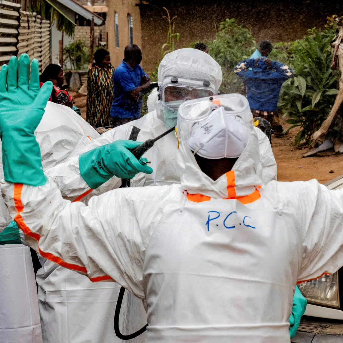 FILE PHOTO: Members of the Civil Protection team, which works to help mitigate the spread of the Ebola virus, wearing personal protective equipment (PPE), disinfect after handling the body of an unidentified man, who according to his family, died of Ebola, in Bunia, Ituri province, Democratic Republic of Congo, July 10, 2026. REUTERS/Gradel Muyisa Mumbere/File Photo