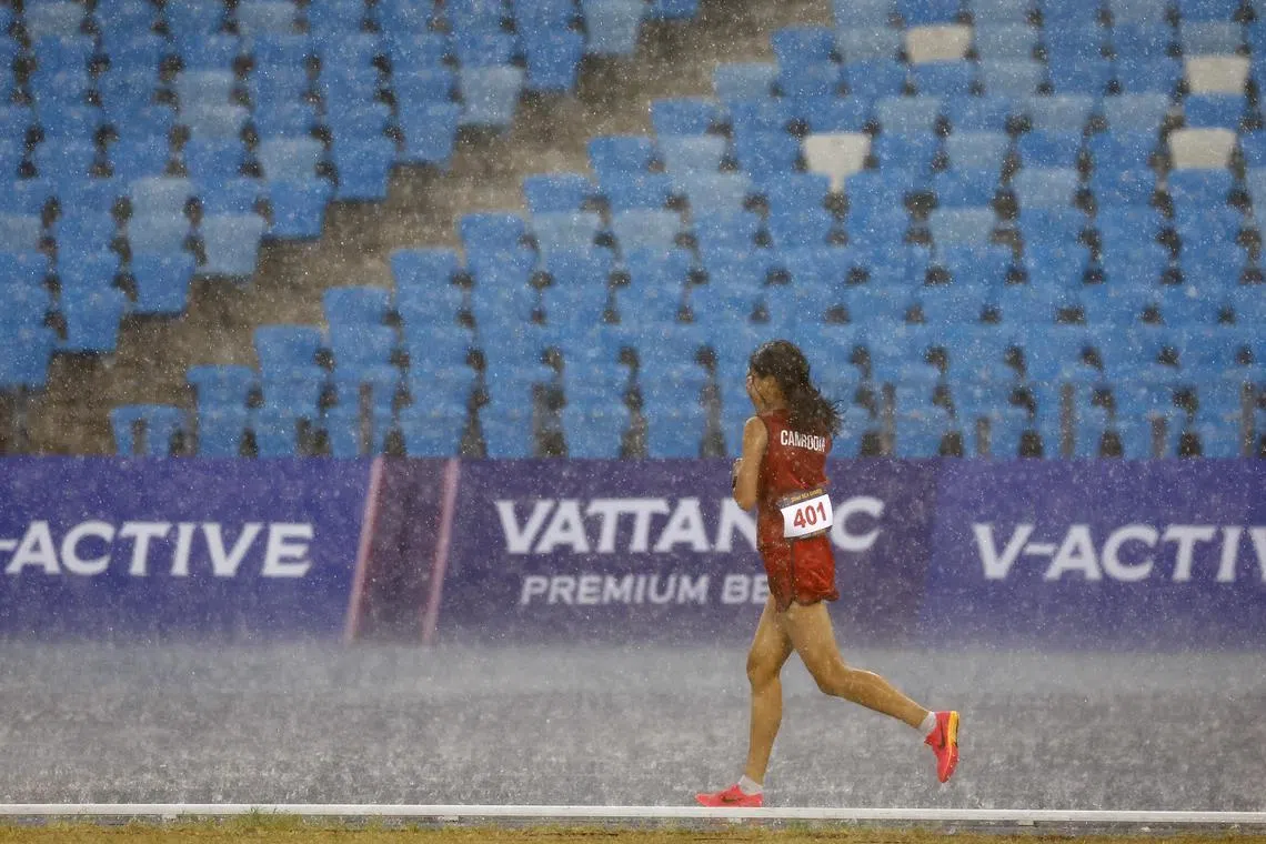 Cambodia's Bou Samnang competing in the 5,000m race. She finished last, but was hailed for her grit. 