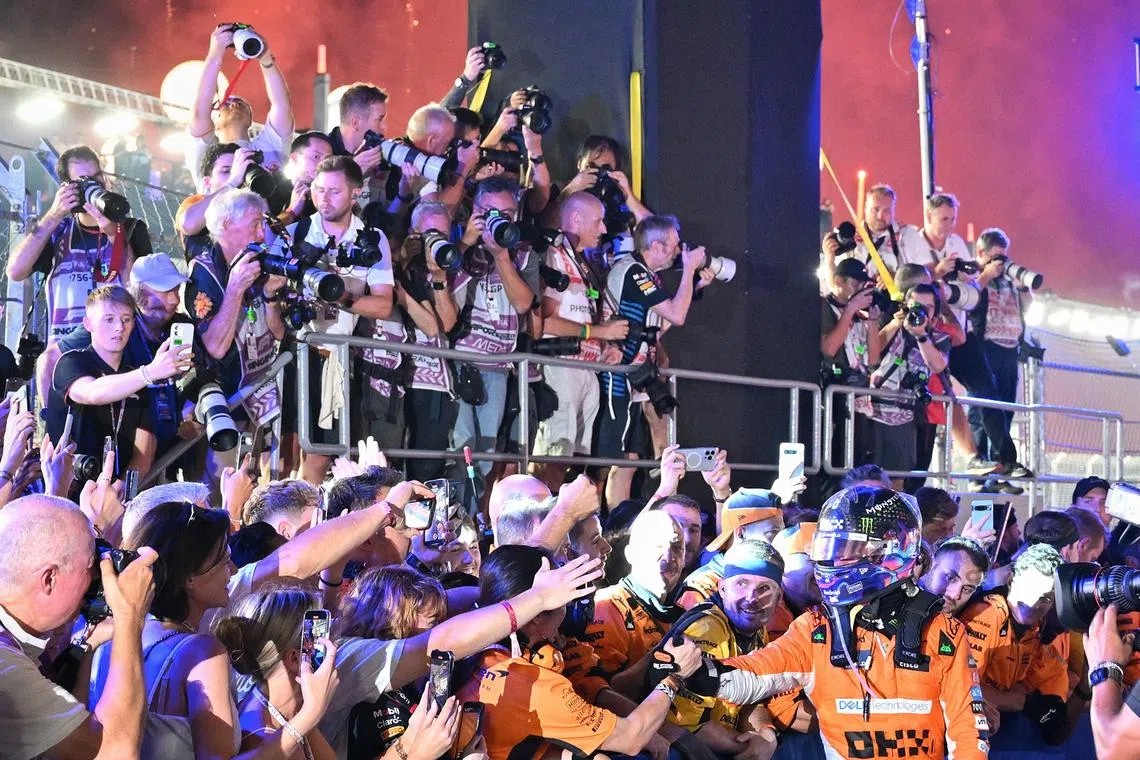 Lando Norris of McLaren congratulated after his success at the Singapore Airlines Singapore Grand Prix on Sept 22, 2024.
