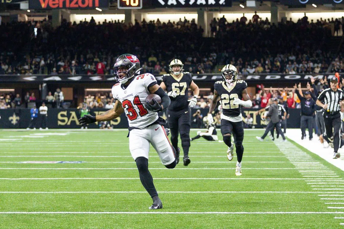 Oct 13, 2024; New Orleans, Louisiana, USA;  Tampa Bay Buccaneers safety Antoine Winfield Jr. (31) return a fumble for a touchdown against New Orleans Saints wide receiver Chris Olave (12) during he first half at Caesars Superdome. Stephen Lew-Imagn Images/File Photo