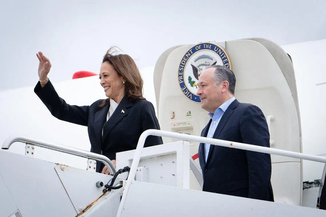 TOPSHOT - US Vice President Kamala Harris and second gentleman Douglas Emhoff descend from Air Force Two at Delaware National Air Guard base in New Castle, Delaware, on July 22, 2024. Harris is set to meet campaign staff in Wilmington. Harris on Monday won the crucial backing of Democratic heavyweight Nancy Pelosi to lead the party against Donald Trump in November after Joe Biden's stunning exit from the 2024 race. As the endorsements stacked up, the 59-year-old Harris made her first public appearance since Biden's announcement in a ceremony at the White House where she warmly praised the outgoing president's "unmatched" achievements. (Photo by Erin SCHAFF / POOL / AFP)