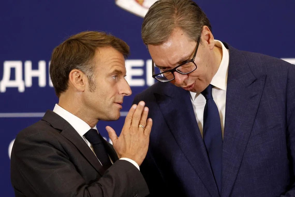French President Emmanuel Macron (left) is welcomed by Serbian President Aleksandar Vucic in Belgrade, on Aug 29.