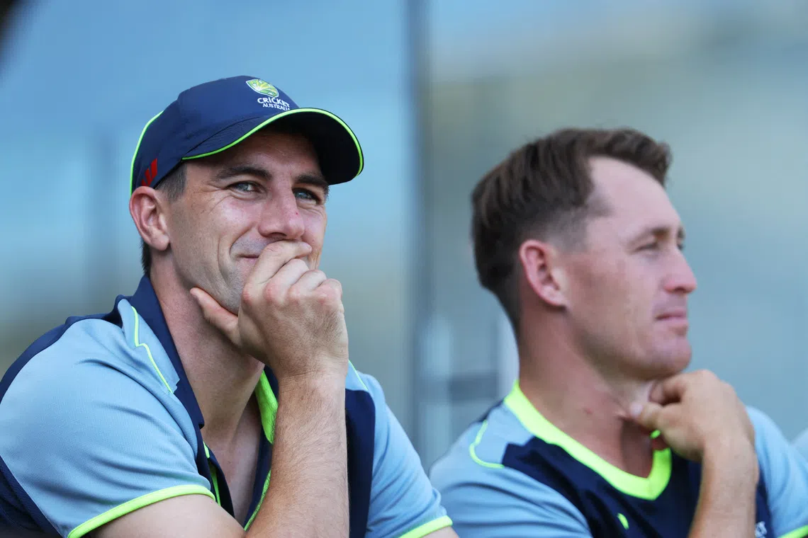 Cricket - The Ashes - Australia v England - Second Test - The Gabba, Brisbane, Australia - December 6, 2025 Australia's Pat Cummins with Marnus Labuschagne in the pavilion. REUTERS/Hollie Adams