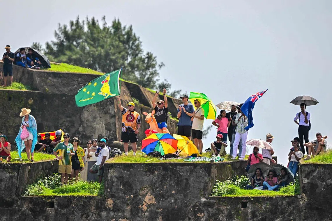 TOPSHOT - Spectators gather over the Galle Fort as they watch the play of the second day of the first Test cricket match between Sri Lanka and Australia at the Galle International Cricket Stadium in Galle on January 30, 2025. (Photo by Ishara S. KODIKARA / AFP)