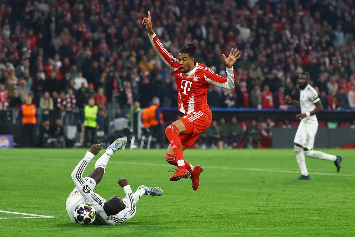 Soccer Football - UEFA Champions League - Quarter Final - Second Leg - Bayern Munich v Real Madrid - Allianz Arena, Munich, Germany - April 15, 2026 Real Madrid's Ferland Mendy in action with Bayern Munich's Michael Olise REUTERS/Kai Pfaffenbach