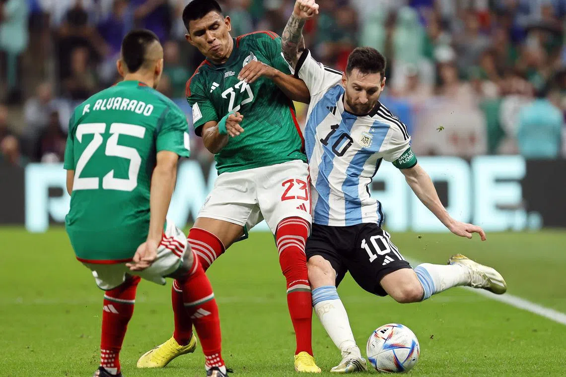 Argentina's Lionel Messi (right) in action tries to get the better of Mexico's Roberto Alvarado (left) and Jesus Gallardo during Saturday's clash.  