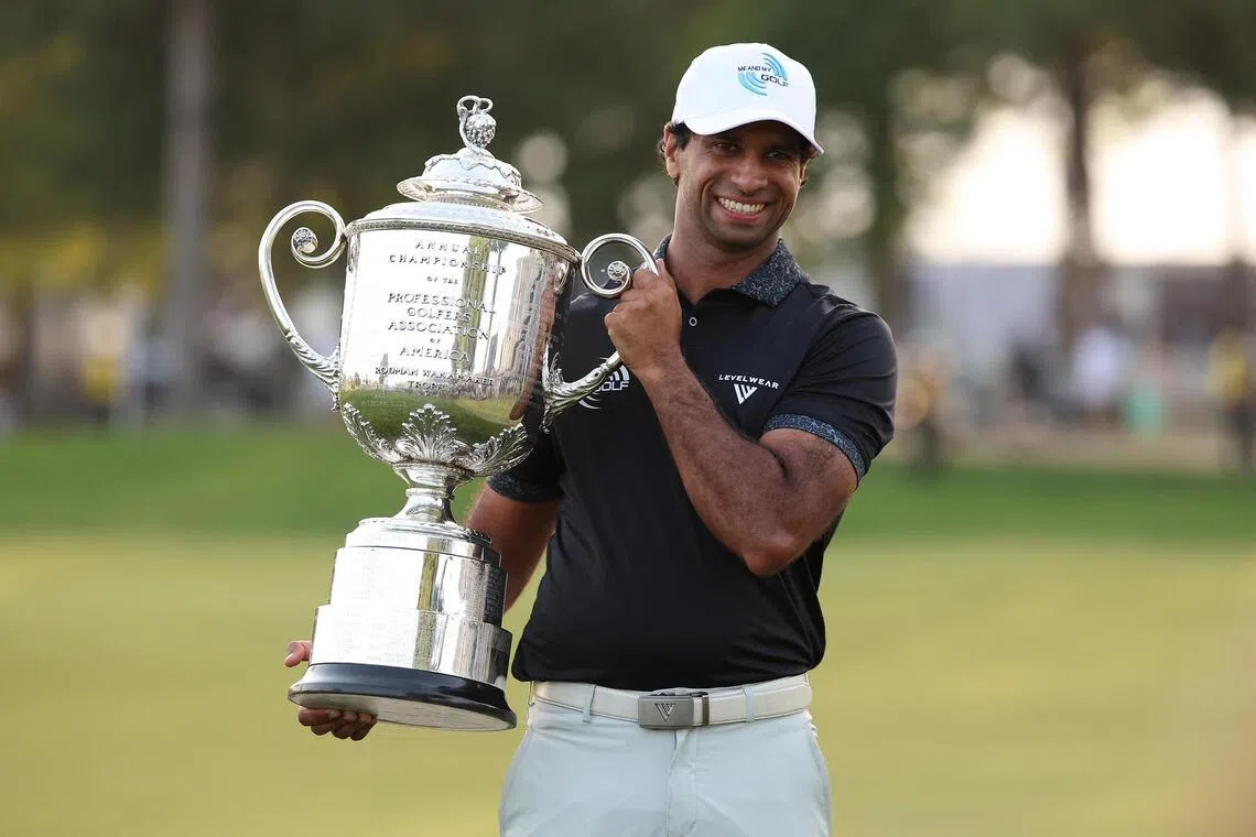 Aaron Rai poses with the trophy after winning the final round of the PGA Championship golf tournament. 