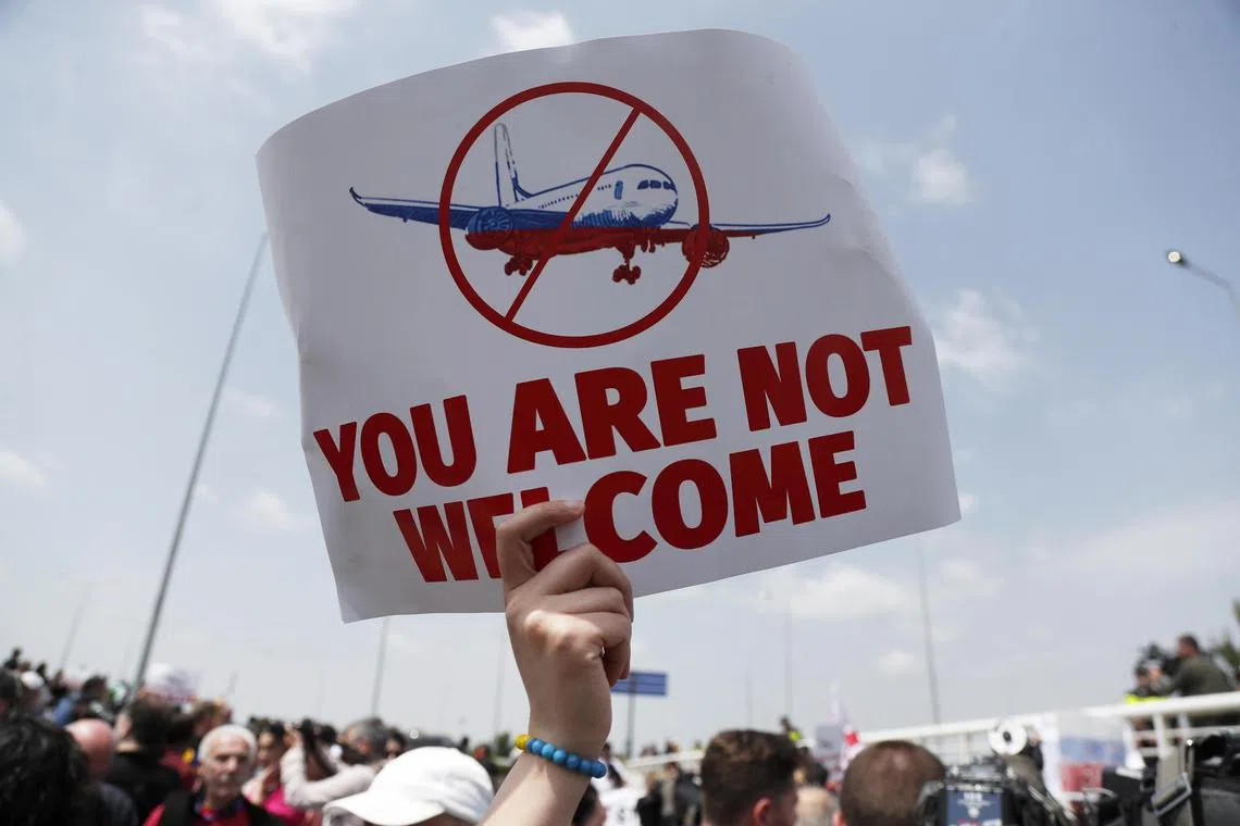 People in Georgia protest against a resumption of air links with Russia, in the capital Tbilisi.