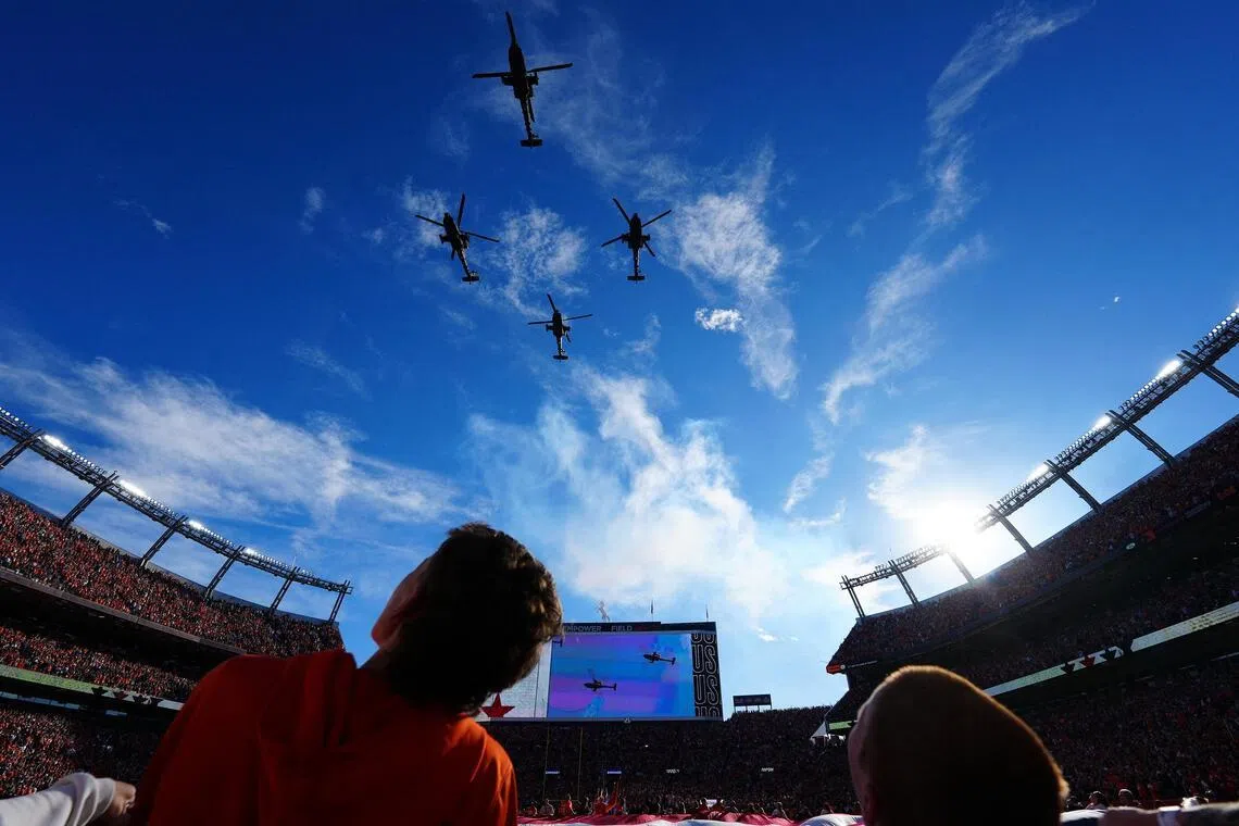Dec 21, 2025; Denver, Colorado, USA; US Army Apache helicopters perform a fly-over before the game at Empower Field at Mile High. Mandatory Credit: Ron Chenoy-Imagn Images