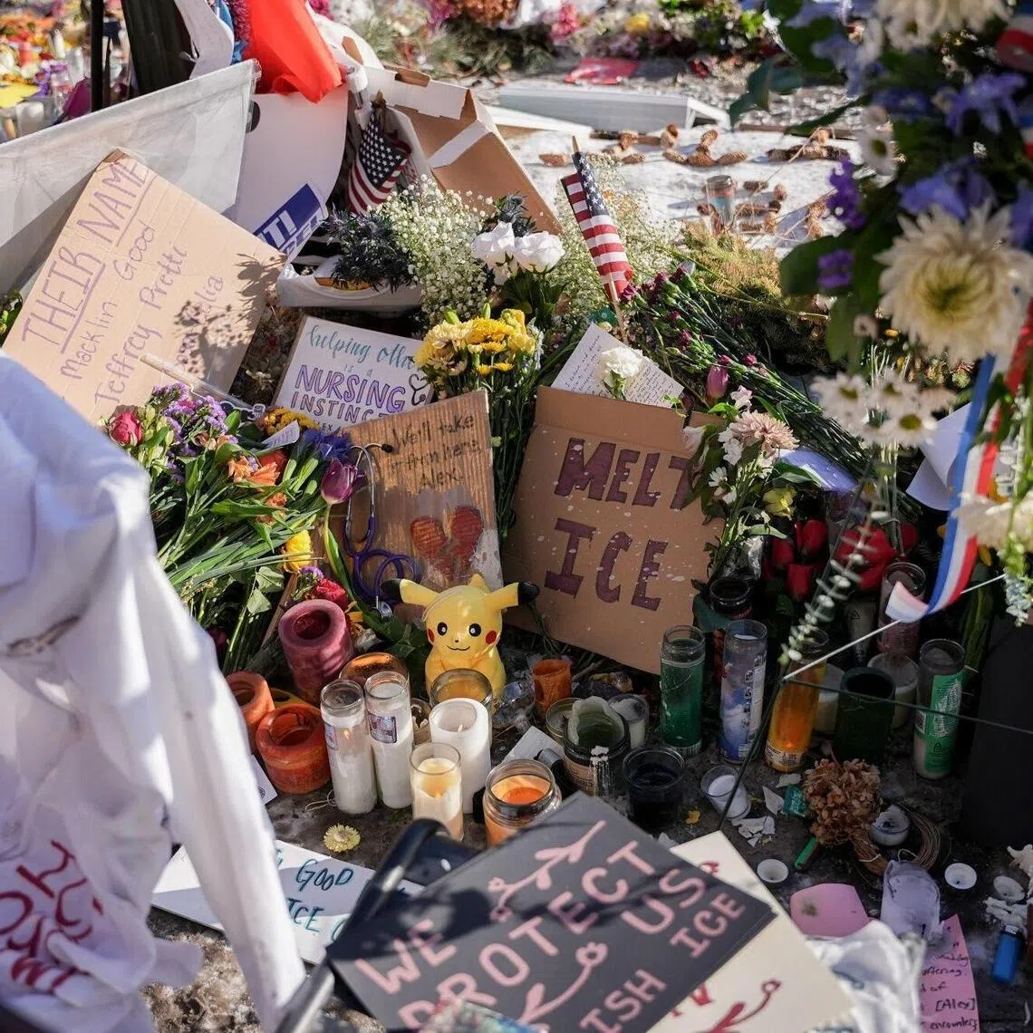 Flowers, candles, and signs left by mourners at a memorial for Alex Pretti near the scene of a fatal shooting by a federal law enforcement officer in Minneapolis.